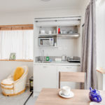 Kitchenette with stove, microwave and fridge
